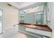 Bright bathroom featuring a spacious counter with a sink, large mirror and an abundance of cabinet space at 2140 Carnac St, Port Charlotte, FL 33952