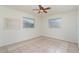 Bright bedroom with tile flooring and ample natural light from two large windows at 2140 Carnac St, Port Charlotte, FL 33952