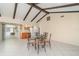 Open concept dining area with beamed ceilings, tile flooring, and a glass sliding door to an outdoor area at 2140 Carnac St, Port Charlotte, FL 33952