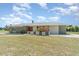 Single-story home with a manicured front lawn, bright entrance, and modern color palette at 2140 Carnac St, Port Charlotte, FL 33952