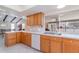 Kitchen with oak cabinets, white countertops, and a view into the living space at 2140 Carnac St, Port Charlotte, FL 33952