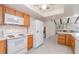 This is a kitchen with oak cabinets, white appliances, and plenty of counter space at 2140 Carnac St, Port Charlotte, FL 33952