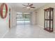 Open-concept living room with tile flooring and sliding glass doors leading to the pool at 2140 Carnac St, Port Charlotte, FL 33952