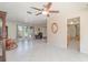 Expansive living area with tile flooring, large windows, and a classic rocking chair at 2140 Carnac St, Port Charlotte, FL 33952