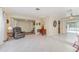 Bright living room with tile floors, neutral walls, and multiple access points to other rooms at 2140 Carnac St, Port Charlotte, FL 33952