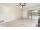 Bright living room with tile floors, ceiling fan, and sliding doors to the backyard pool at 2140 Carnac St, Port Charlotte, FL 33952