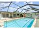 Inviting pool with screened enclosure, a beautiful patio and the backyard is ideal for outdoor enjoyment at 2140 Carnac St, Port Charlotte, FL 33952