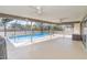 Enclosed pool area with tiled flooring, ceiling fans and nice screening, perfect for relaxing or entertaining guests at 2140 Carnac St, Port Charlotte, FL 33952