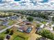 Drone view of the property displaying its location within a vibrant and lush residential area at 23347 Lehigh Ave, Port Charlotte, FL 33954