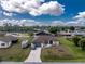 Charming single-story home featuring a well-manicured lawn, RV parking, and a large driveway leading to a two-car garage at 23347 Lehigh Ave, Port Charlotte, FL 33954