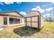 Backyard view of the home exterior and shed at 23347 Lehigh Ave, Port Charlotte, FL 33954