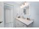 Bright bathroom with a modern vanity, light countertop, decorative mirror, and updated fixtures at 23347 Lehigh Ave, Port Charlotte, FL 33954