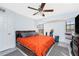 Bedroom featuring ceiling fan, window, and an orange bedspread at 23347 Lehigh Ave, Port Charlotte, FL 33954