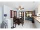 Cozy dining area with tiled floors, a view of the screened-in lanai, and adjacent to kitchen features at 23347 Lehigh Ave, Port Charlotte, FL 33954