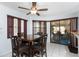 Cozy dining area with tiled floors, a view of the screened-in lanai, and adjacent to kitchen features at 23347 Lehigh Ave, Port Charlotte, FL 33954