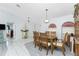 Bright dining room with wood table and chairs, view to front door with transom window at 23347 Lehigh Ave, Port Charlotte, FL 33954