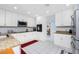Bright kitchen featuring granite countertops, white cabinetry, stainless steel appliances, and an adjoining breakfast nook at 23347 Lehigh Ave, Port Charlotte, FL 33954