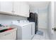 Well-lit laundry room with washer, dryer, and storage at 23347 Lehigh Ave, Port Charlotte, FL 33954