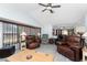 Spacious living room with vaulted ceiling, ceiling fan, and an open layout leading to other parts of the house at 23347 Lehigh Ave, Port Charlotte, FL 33954