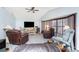 Bright living room featuring vaulted ceiling, ceiling fan, and cozy seating arrangement, offering relaxed living space at 23347 Lehigh Ave, Port Charlotte, FL 33954