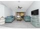 Bright living room with ceiling fan offering comfortable seating and sliding glass doors to screened pool at 23347 Lehigh Ave, Port Charlotte, FL 33954