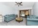 Living room with ceiling fan and sliding glass doors that open to the screened in pool at 23347 Lehigh Ave, Port Charlotte, FL 33954