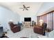 Bright living room features vaulted ceiling, ceiling fan, TV, and cozy seating arrangement, offering relaxed living space at 23347 Lehigh Ave, Port Charlotte, FL 33954