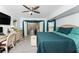 Serene main bedroom with a ceiling fan, ample natural light, and access to the screened-in patio at 23347 Lehigh Ave, Port Charlotte, FL 33954