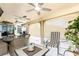 Relaxing outdoor patio featuring comfortable seating, ceiling fans, and views of the screened-in pool area at 23347 Lehigh Ave, Port Charlotte, FL 33954