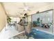 A spacious patio with dining area, ceiling fans, and access to the pool area at 23347 Lehigh Ave, Port Charlotte, FL 33954