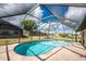 Backyard pool with a screened enclosure and surrounding patio at 23347 Lehigh Ave, Port Charlotte, FL 33954