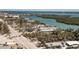 Charming waterfront property with a tranquil bay view and multiple buildings surrounded by mature palm trees at 2450 N Beach Rd # 231, Englewood, FL 34223