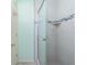 Bathroom with a shower that has a glass door and light gray tile at 2450 N Beach Rd # 231, Englewood, FL 34223
