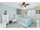Cozy bedroom with a ceiling fan, comfortable bed, and serene blue accents at 2450 N Beach Rd # 231, Englewood, FL 34223