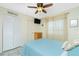 Bedroom features a queen bed, ceiling fan, tile flooring, and white closet at 2450 N Beach Rd # 231, Englewood, FL 34223