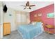 Bedroom featuring a queen bed, rattan headboard, ceiling fan, and tile flooring at 2450 N Beach Rd # 231, Englewood, FL 34223