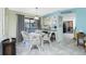 Bright dining area with seating for four, bar seating, and tile flooring at 2450 N Beach Rd # 231, Englewood, FL 34223