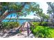 Charming wooden dock surrounded by greenery and calm waters, offering tranquil access to the bay at 2450 N Beach Rd # 231, Englewood, FL 34223