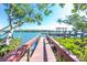 Scenic dock leading to a covered gazebo on the water, framed by lush trees and mangroves, offering serene views at 2450 N Beach Rd # 231, Englewood, FL 34223
