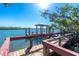 Picturesque dock featuring a gazebo, seating, and views of the surrounding water, mangroves, and shoreline at 2450 N Beach Rd # 231, Englewood, FL 34223