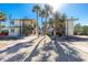Two-story condo buildings feature sunny exteriors, palm trees, and gravel pathways at 2450 N Beach Rd # 231, Englewood, FL 34223
