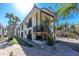 Bright two-story condo with a black-railed deck, palm trees, and neutral siding for a modern beachy vibe at 2450 N Beach Rd # 231, Englewood, FL 34223