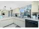 Well-lit kitchen featuring ample counter space, tile flooring, and a sunny window at 2450 N Beach Rd # 231, Englewood, FL 34223