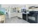Inviting kitchen with tile floors, black appliances, and ample storage at 2450 N Beach Rd # 231, Englewood, FL 34223