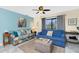 Comfortable living room with ceiling fan, tile floors, and large window at 2450 N Beach Rd # 231, Englewood, FL 34223