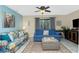 Cozy living room with comfortable seating, tile floors, and ceiling fan at 2450 N Beach Rd # 231, Englewood, FL 34223
