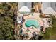 Aerial view of a Kidney-shaped pool with lounge chairs and tropical landscaping, perfect for relaxation and leisure at 2450 N Beach Rd # 231, Englewood, FL 34223