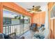 Cozy porch features screened windows, a ceiling fan, and comfortable seating at 2450 N Beach Rd # 231, Englewood, FL 34223