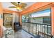 Cozy porch featuring screened windows, tiled floor, and comfortable wicker seating at 2450 N Beach Rd # 231, Englewood, FL 34223