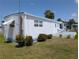 Charming single-story home with well-maintained yard, patio, and lovely blue trim at 248 Outer E Dr, Venice, FL 34285